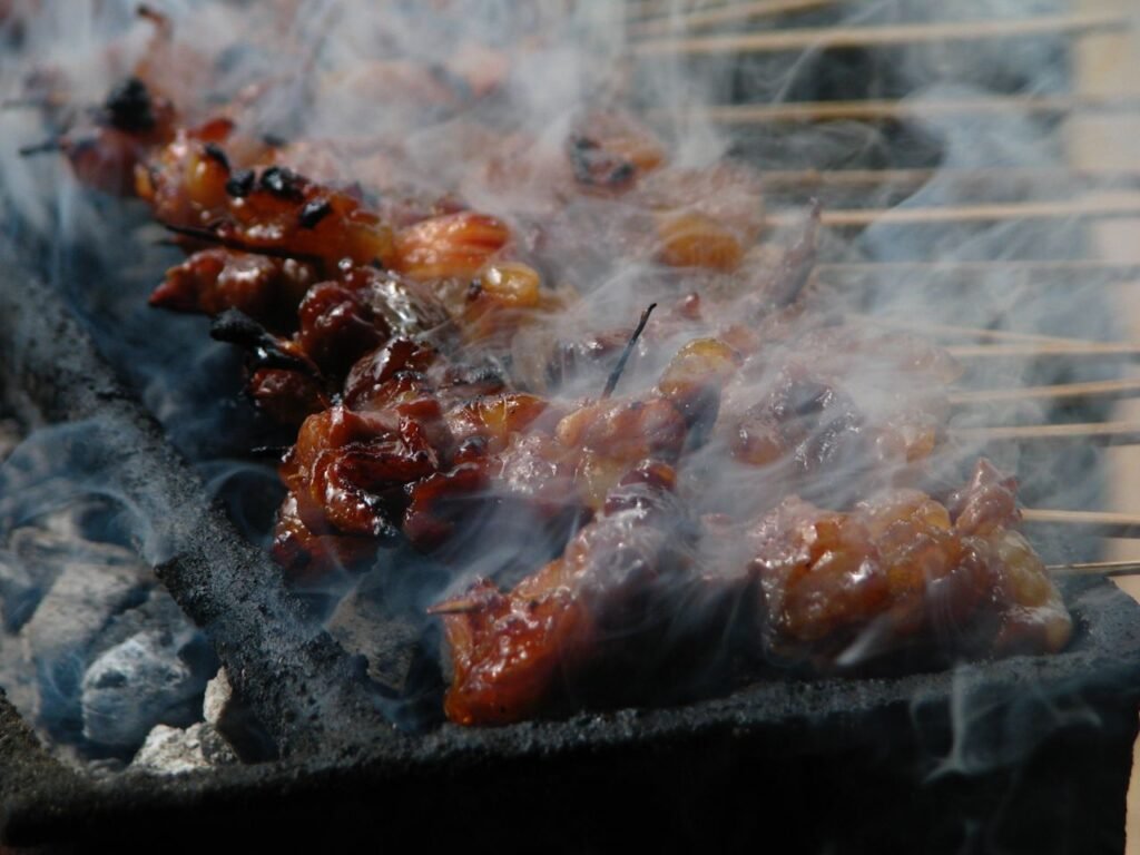Close-up of delicious grilled meat skewers with a smoky aroma.